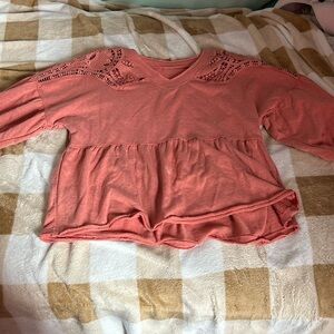 pink top with patterned cut sleeves